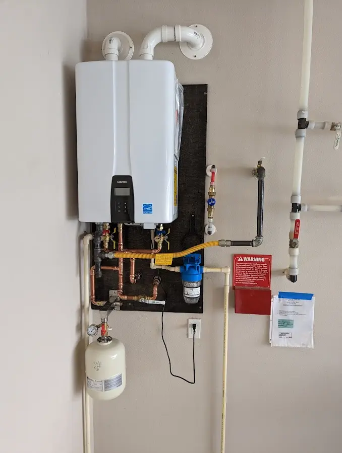 Professional plumber installing copper piping in a St. James home